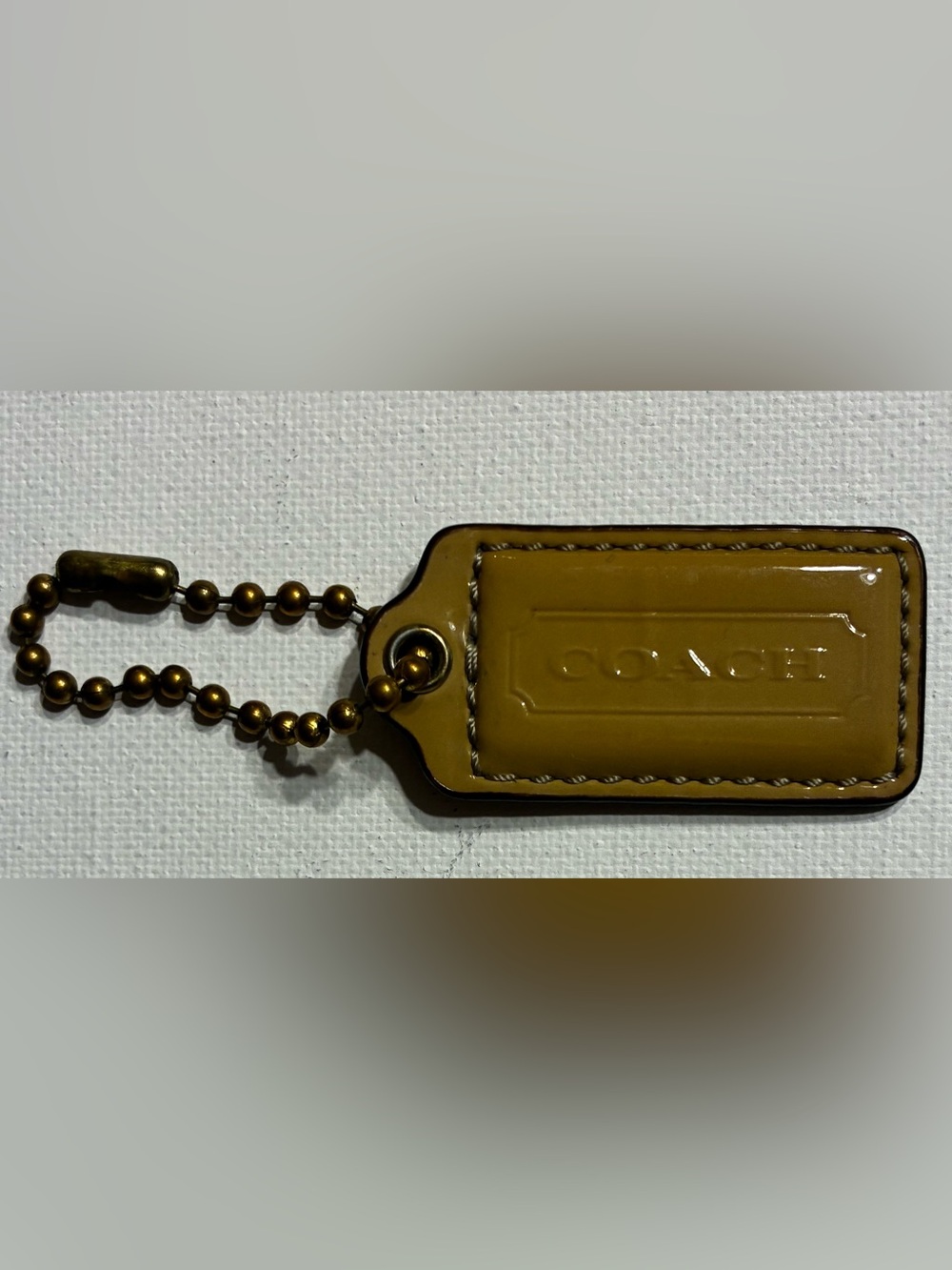 Coach EUC Mustard  Patent Leather Hang Tag Keychain @2”